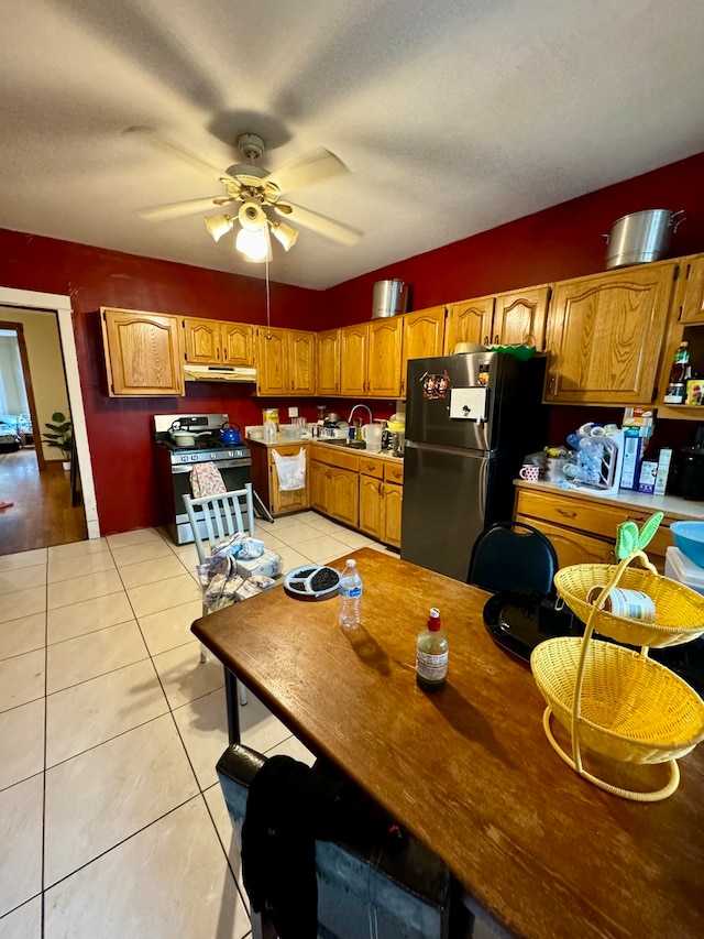 kitchen featuring ceiling fan, sink, appliances with stainless steel finishes, and light tile patterned floors