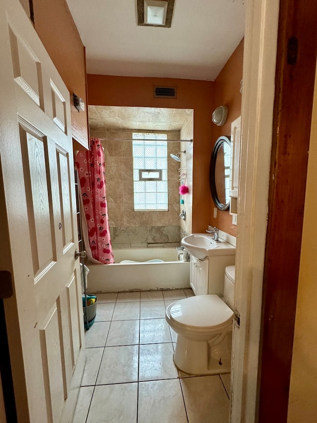 full bathroom with shower / tub combo, tile patterned flooring, vanity, and toilet