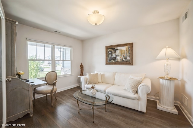 living room featuring ornate columns and dark hardwood / wood-style floors