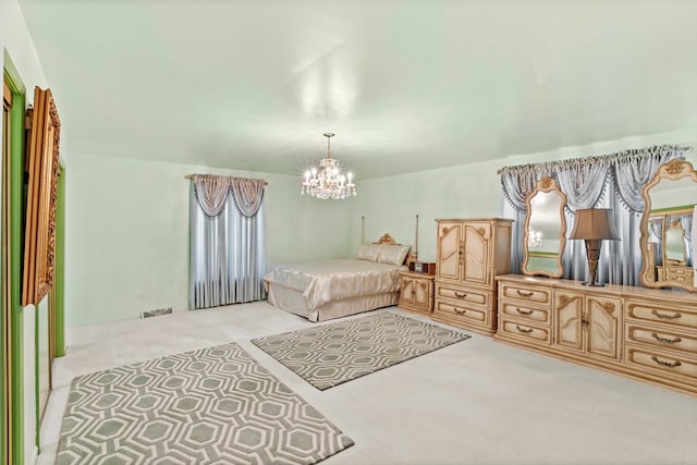 carpeted bedroom with a chandelier