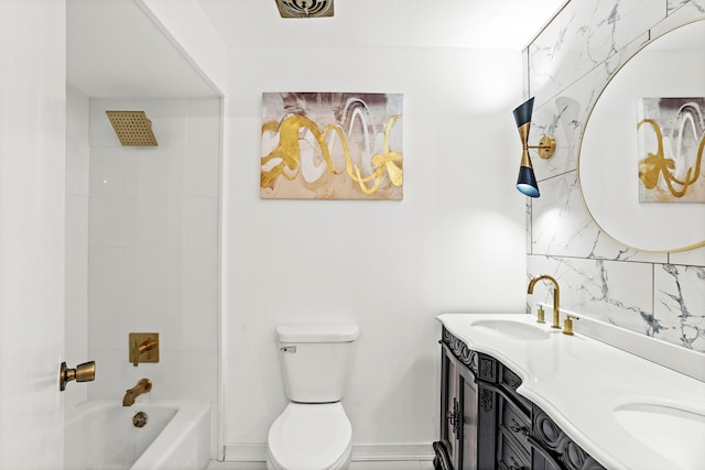 full bathroom featuring tiled shower / bath, double sink vanity, and toilet