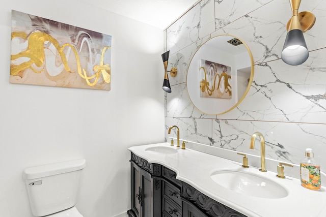 bathroom with double sink vanity, backsplash, and toilet