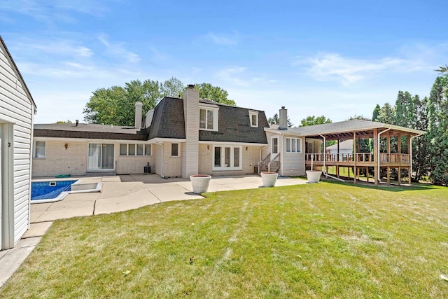 rear view of house with a patio area, a gazebo, and a lawn