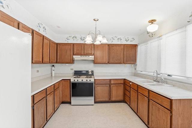 kitchen with a chandelier, light tile patterned floors, decorative light fixtures, white appliances, and sink