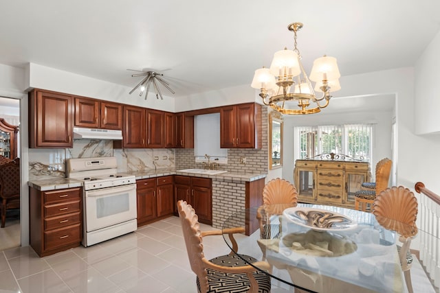 kitchen with a notable chandelier, light tile patterned flooring, decorative light fixtures, white range with gas stovetop, and sink