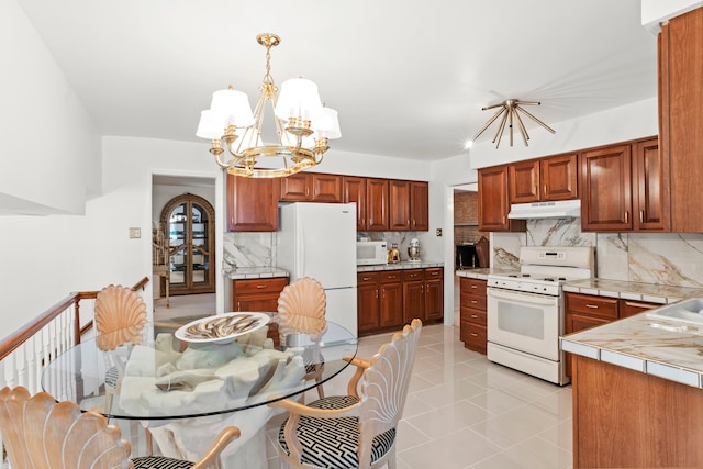 kitchen with tasteful backsplash, a chandelier, white appliances, and light tile patterned floors