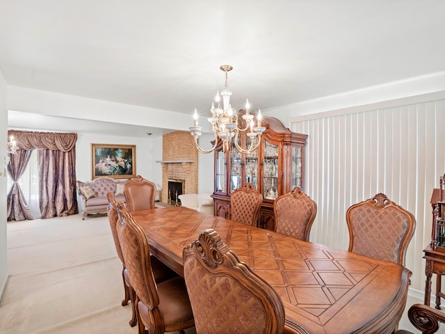 dining area with a fireplace, a healthy amount of sunlight, a chandelier, light colored carpet, and brick wall