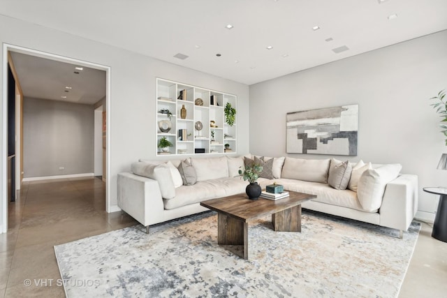 living area featuring concrete floors, recessed lighting, and baseboards