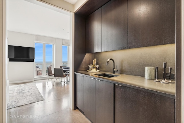 kitchen featuring dark brown cabinets, modern cabinets, and a sink