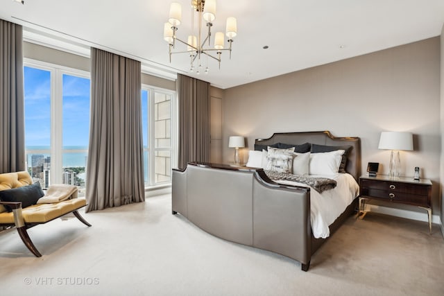 carpeted bedroom featuring a chandelier and a water view