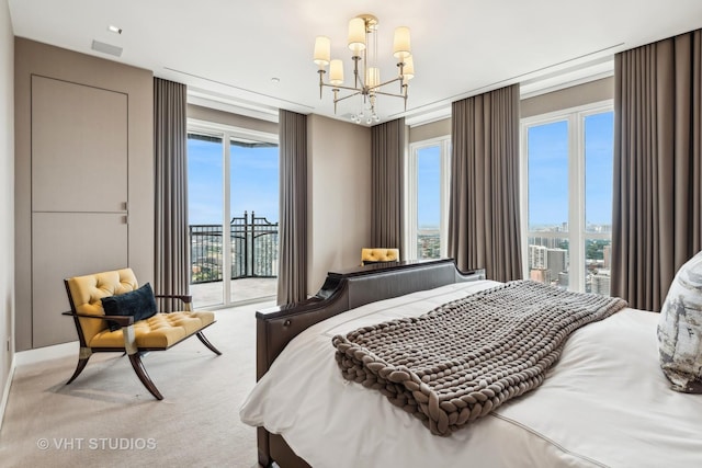 carpeted bedroom with access to outside, a city view, and a notable chandelier