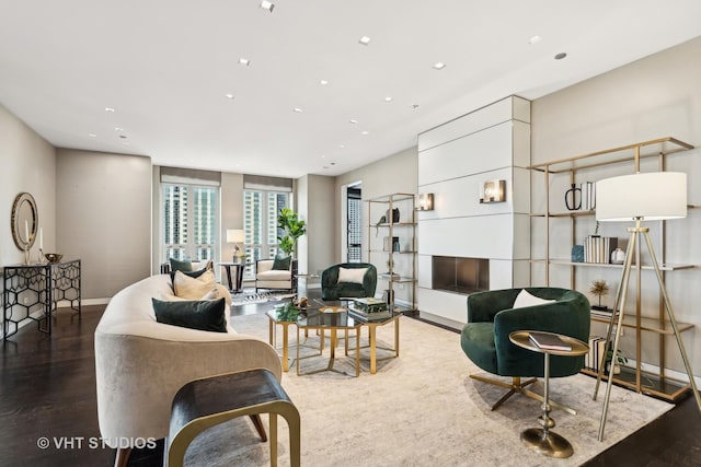 living room with recessed lighting, baseboards, and wood finished floors