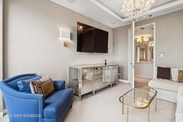 living area with a raised ceiling, a notable chandelier, and wallpapered walls