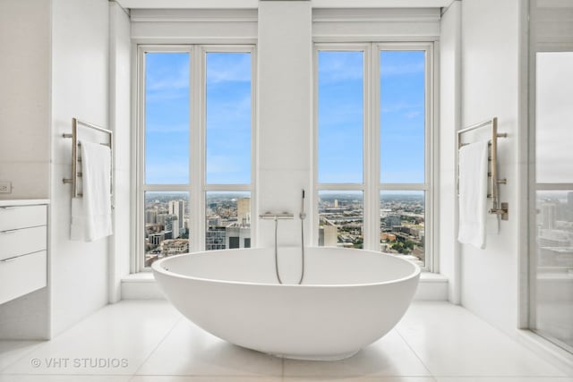 bathroom with tile patterned floors and a healthy amount of sunlight