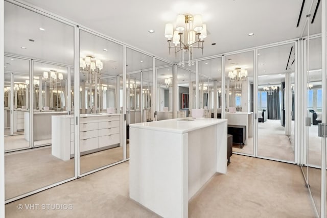 spacious closet featuring a chandelier