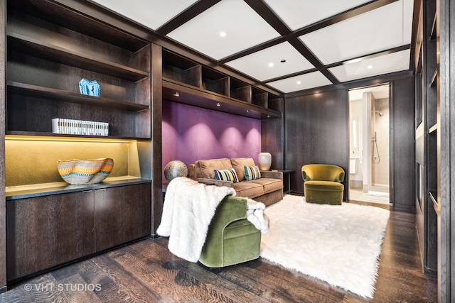 interior space with coffered ceiling, built in shelves, and dark hardwood / wood-style flooring