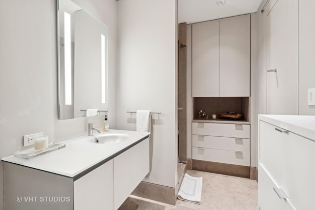 bathroom featuring a shower and vanity