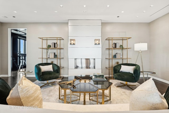 living area with recessed lighting, wood finished floors, and baseboards