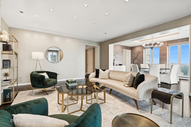 living room featuring a baseboard radiator, baseboards, a chandelier, and recessed lighting