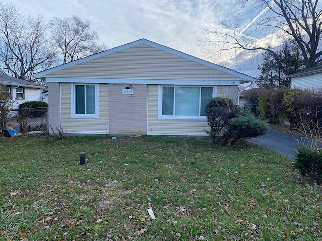 rear view of house featuring a yard