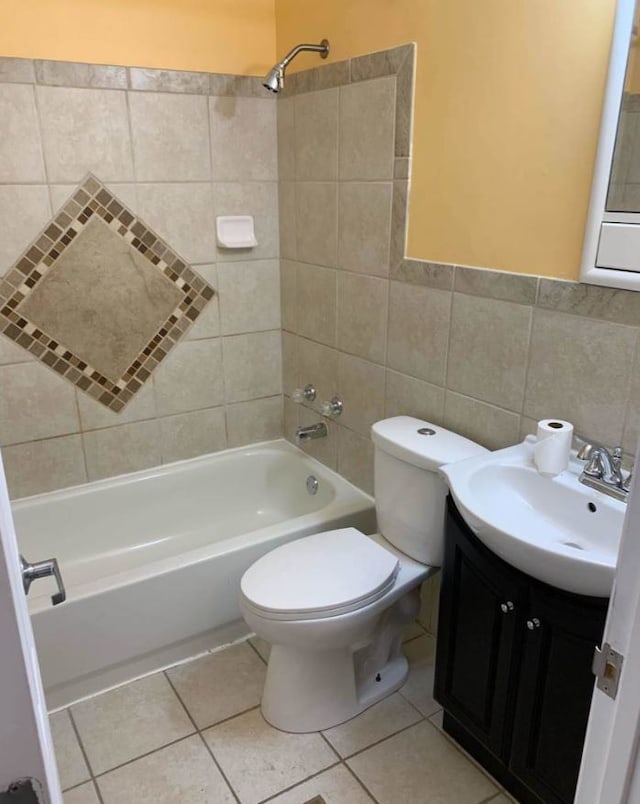 full bathroom with vanity, tiled shower / bath, tile patterned flooring, and toilet