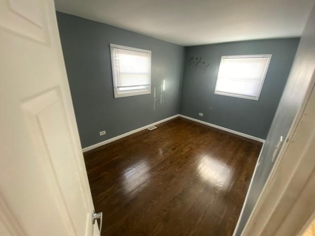 spare room featuring dark hardwood / wood-style floors