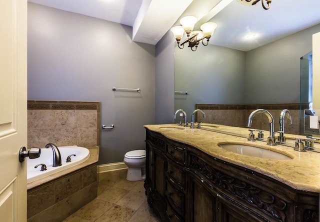 bathroom featuring tile patterned floors, toilet, vanity, a notable chandelier, and a relaxing tiled tub