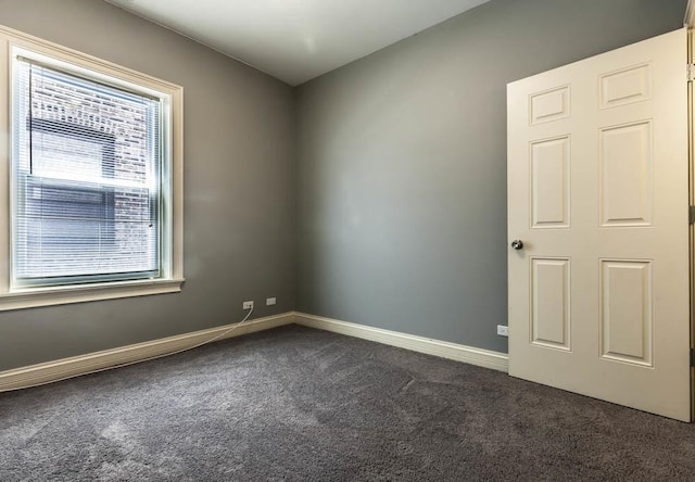 empty room featuring dark colored carpet