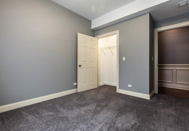 unfurnished bedroom with dark carpet