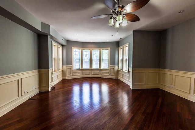 spare room featuring dark wood-type flooring and ceiling fan