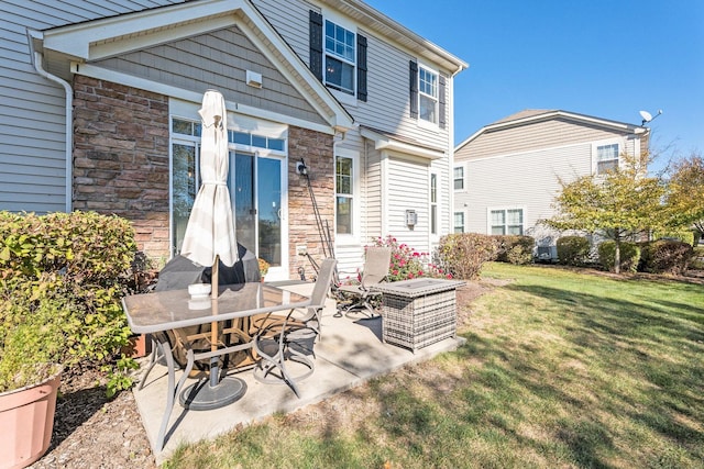 34W685 Roosevelt Ave Unit A, Saint Charles, IL 60174 - back of property with a lawn, stone siding, and a patio