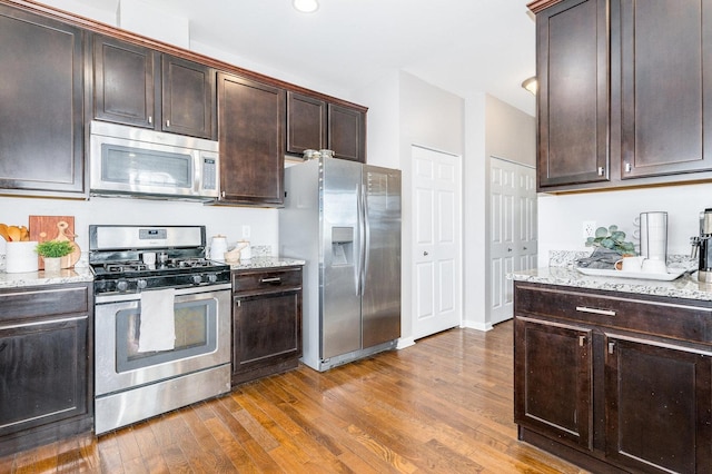 34W685 Roosevelt Ave Unit A, Saint Charles, IL 60174 - kitchen featuring appliances with stainless steel finishes, wood finished floors, dark brown cabinets, light stone counters, and recessed lighting