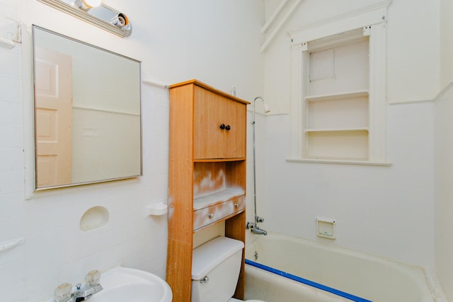 full bathroom featuring sink, bathtub / shower combination, and toilet