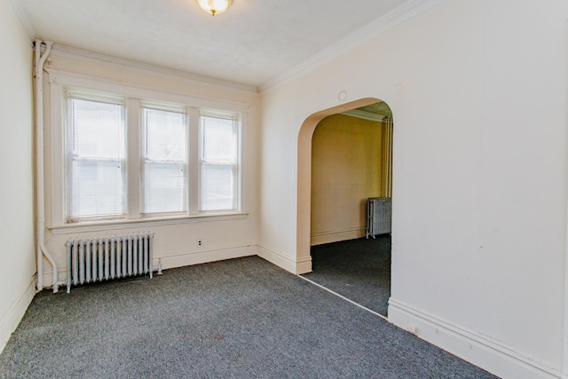 carpeted spare room with ornamental molding and radiator heating unit