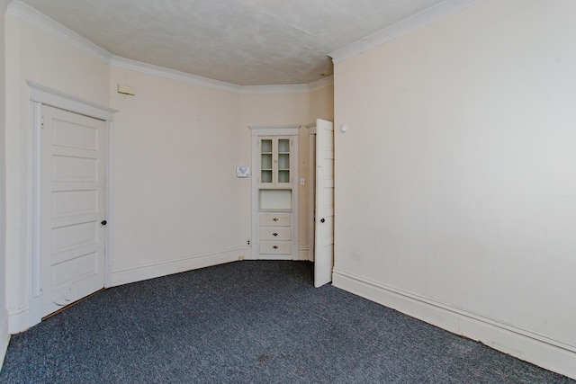 carpeted spare room featuring ornamental molding