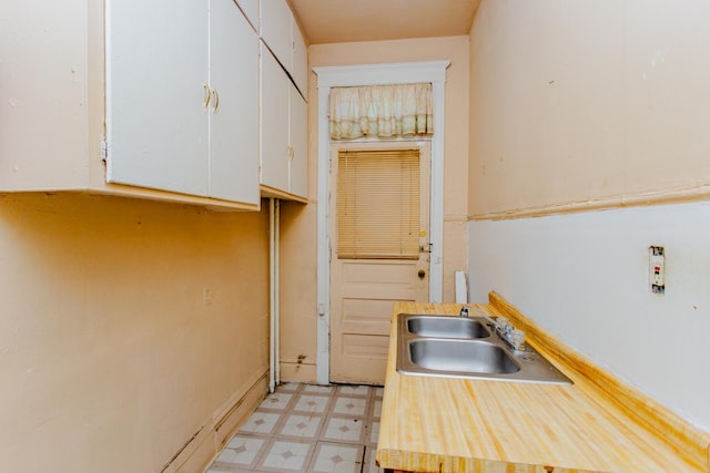 kitchen featuring sink and white cabinets