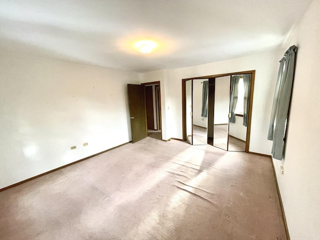 unfurnished bedroom featuring light colored carpet