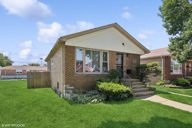 1953 E 93rd St, Chicago, IL 60617 - bungalow-style house featuring a front lawn, crawl space, fence, and brick siding