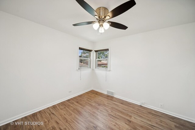 empty room with ceiling fan and light wood-type flooring