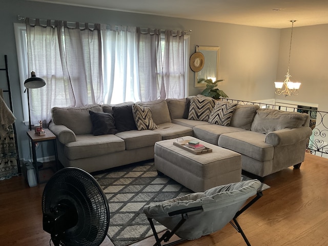 living room with a notable chandelier and hardwood / wood-style floors