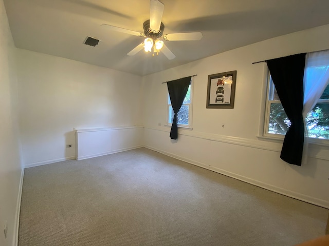 unfurnished room with carpet and ceiling fan