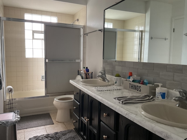 full bathroom featuring enclosed tub / shower combo, toilet, tile patterned flooring, double sink vanity, and tasteful backsplash