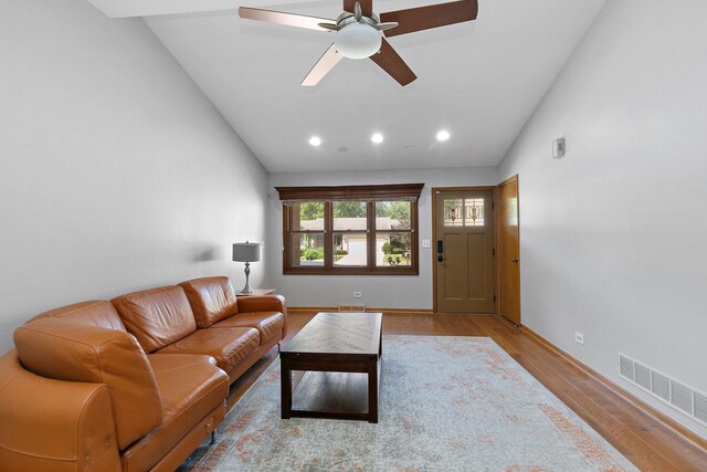 living room featuring high vaulted ceiling, light wood-type flooring, and ceiling fan