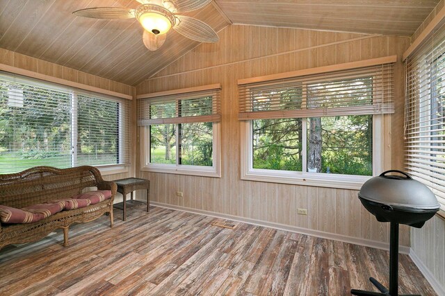 sunroom featuring ceiling fan, vaulted ceiling, and wooden ceiling