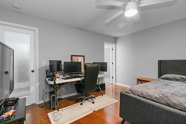 bedroom with hardwood / wood-style floors and ceiling fan