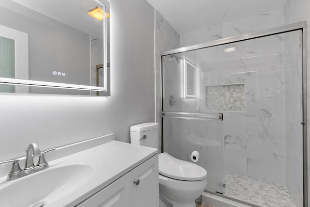 bathroom featuring walk in shower, vanity, and toilet