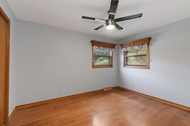 empty room featuring wood-type flooring and ceiling fan