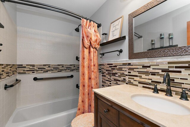 full bathroom featuring shower / tub combo, tasteful backsplash, toilet, tile walls, and vanity