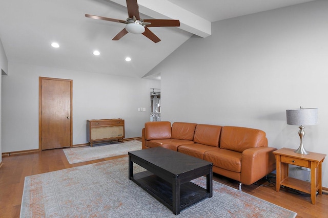 living room featuring wood-type flooring, vaulted ceiling with beams, and ceiling fan