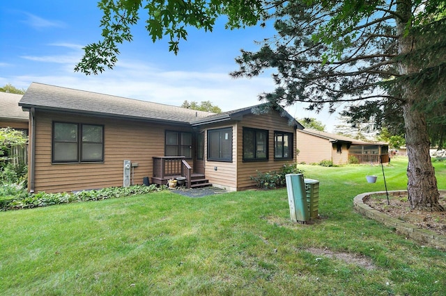 rear view of property with a lawn